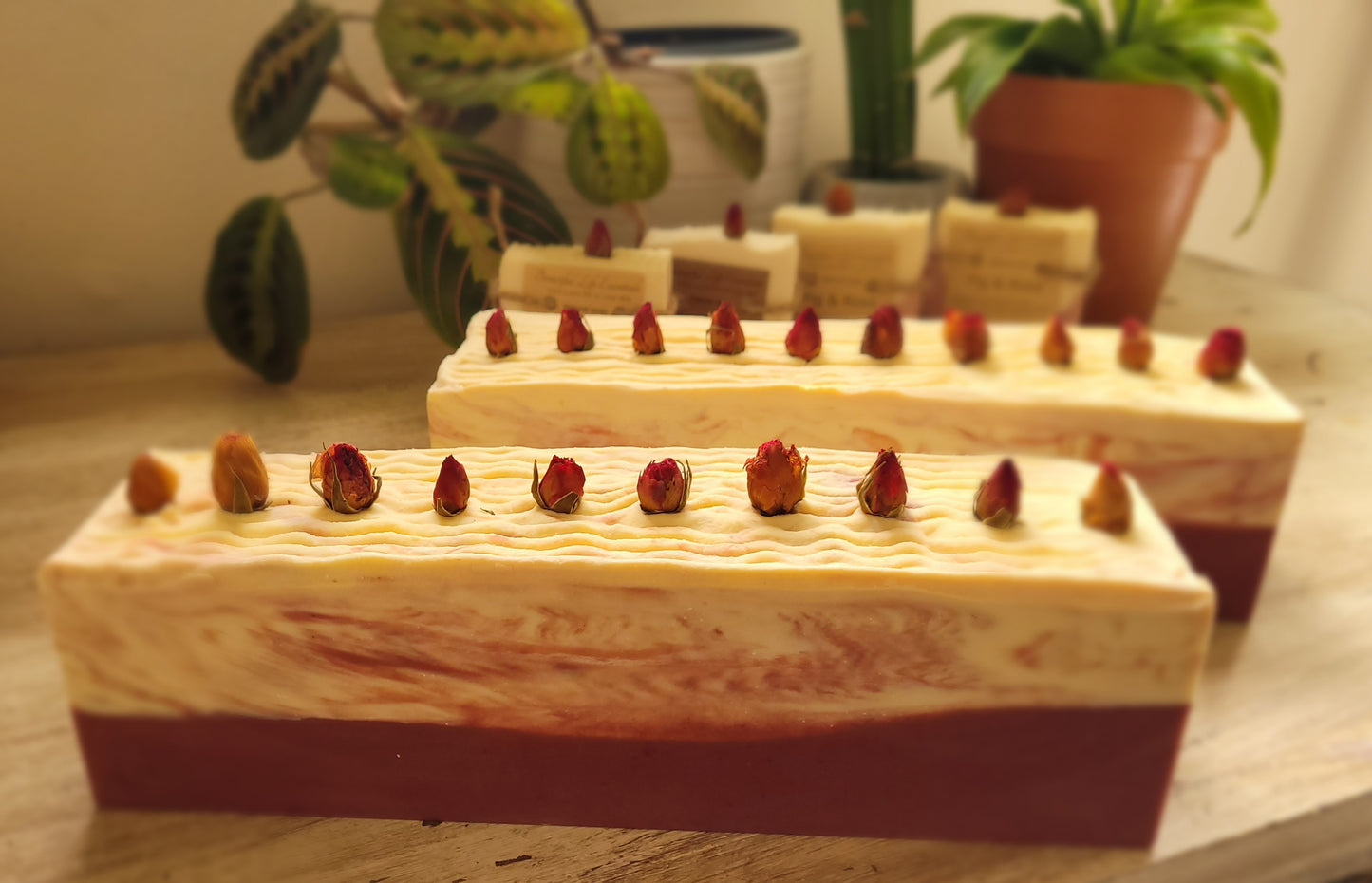 Close-up of natural vegan soap with a creamy texture, featuring rose petals from our family garden and a blend of fig and rose fragrance for a soothing bath.